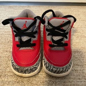 Red, black, and grey baby Jordan shoes